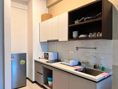 a kitchen with a sink and a refrigerator at Opus KL Residences 1BR near TRX - Living Signature in Kuala Lumpur