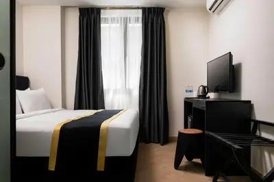 a hotel room with a bed and a television at BRYQS Hotel in Kuala Lumpur