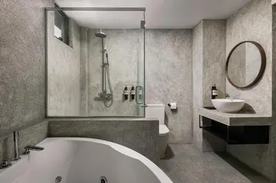 a bathroom with a tub and a toilet and a sink at BRYQS Hotel in Kuala Lumpur