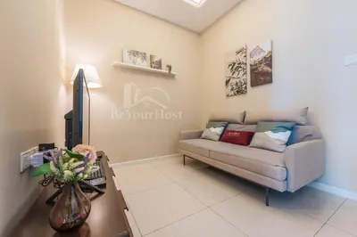 a living room with a couch and a table at Dorsett Residences Sri Hartamas [5 Star Suites] in Kuala Lumpur