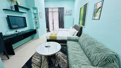 a living room with a couch and a table at Taragon Apartment - KL ,Malaysia in Kuala Lumpur
