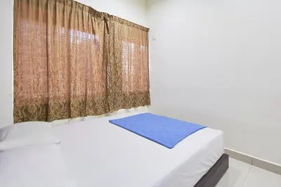 a bedroom with a bed and a curtain at Hotel 3Winz Chow Kit Kuala Lumpur in Kuala Lumpur