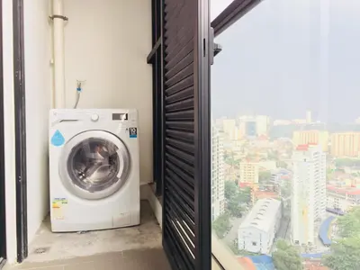 a washing machine in a room with a window at Establishment Bangsar By Sleepy Bear in Kuala Lumpur