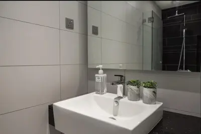 a white sink in a bathroom with a mirror at Anggun Residence KLCC By Sleepy Bear in Kuala Lumpur