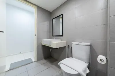 a bathroom with a white toilet and a sink at Eko Cheras By Sleepy Bear in Kuala Lumpur