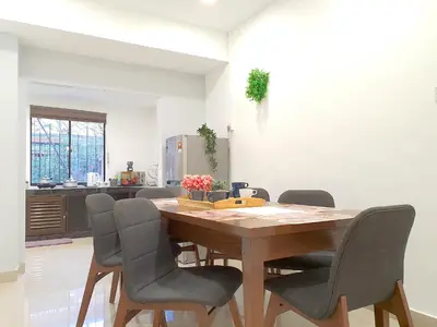 a dining room with a wooden table and chairs at Kuala Lumpur Jalan Ipoh Terrace House in Kuala Lumpur