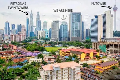 a city with skyscrapers and a city with buildings at Valencia Dorm at Mercu Summer Suites KLCC in Kuala Lumpur