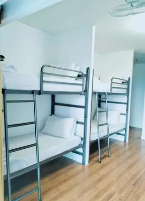 two bunk beds in a room with a wooden floor at Valencia Dorm at Mercu Summer Suites KLCC in Kuala Lumpur