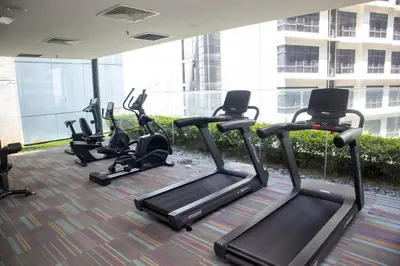 a group of exercise bikes in a gym at Valencia Dorm at Mercu Summer Suites KLCC in Kuala Lumpur