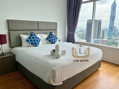 a bedroom with a large bed with a large window at Luxe Suites at Vortex KLCC in Kuala Lumpur