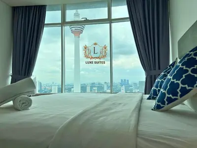 a hotel room with a view of the leus stripes sign at Luxe Suites at Vortex KLCC in Kuala Lumpur