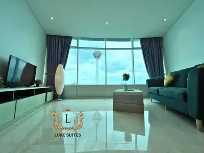 a living room with a blue couch and a large window at Luxe Suites at Vortex KLCC in Kuala Lumpur