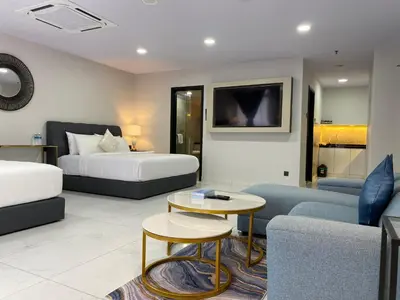 a living room with two beds and a couch at Serviced Apartments at Times Square Kuala Lumpur by Robinsons in Kuala Lumpur