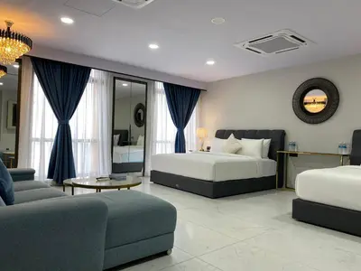 a hotel room with two beds and a couch at Serviced Apartments at Times Square Kuala Lumpur by Robinsons in Kuala Lumpur