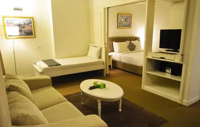 a living room with a couch and a tv at Serviced Apartments at Times Square Kuala Lumpur by Robinsons in Kuala Lumpur