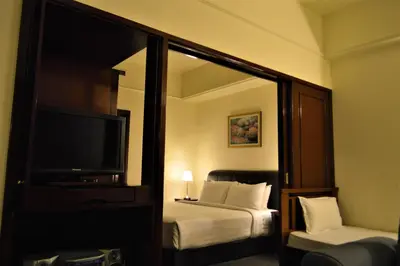 a hotel room with a bed and a television at Serviced Apartments at Times Square Kuala Lumpur by Robinsons in Kuala Lumpur