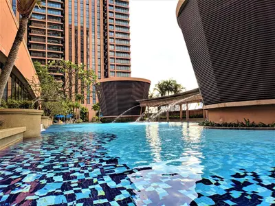 a pool with a fountain in the middle of a city at Serviced Apartments at Times Square Kuala Lumpur by Robinsons in Kuala Lumpur