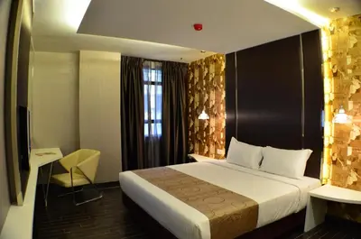 a hotel room with a bed and a window at Kingston Hotel 3 - Kuala Lumpur in Kuala Lumpur