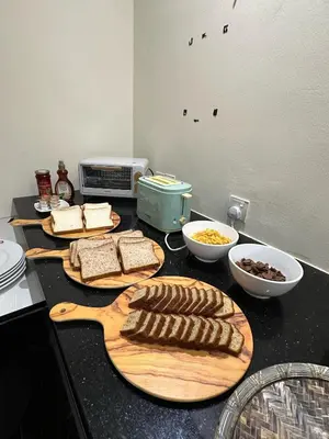 a kitchen counter with two cutting boards with food on it at Kingston Hotel 3 - Kuala Lumpur in Kuala Lumpur
