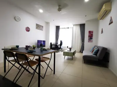 a living room with a table and chairs and a couch at ARCORIS, MONT KIARA by MK HOME in Kuala Lumpur