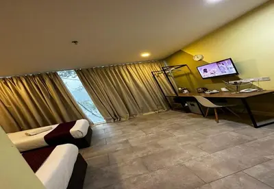 a hotel room with a bed and a desk with a computer at T-hotel Mont Kiara in Kuala Lumpur