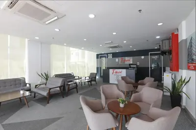 a waiting room with chairs and tables in a building at T-hotel Mont Kiara in Kuala Lumpur