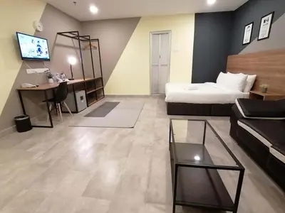 a living room with a bed and a couch at T-hotel Mont Kiara in Kuala Lumpur