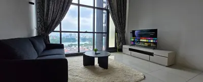 a living room with a couch and a tv and a table at Infinity KLCC Pool at M City Ampang in Kuala Lumpur