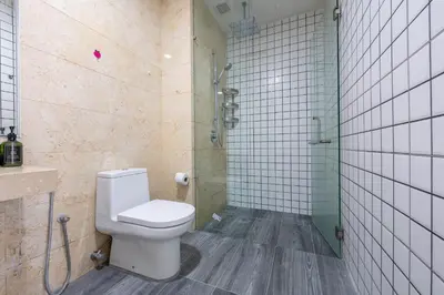a bathroom with a toilet and a shower at Infinity KLCC Pool at M City Ampang in Kuala Lumpur