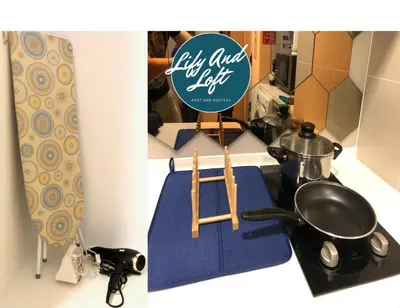 a kitchen counter with a kitchen utensils and a sign at Lily and Loft - KL Gateway Bangsar LRT, WIFI, Netflix in Kuala Lumpur