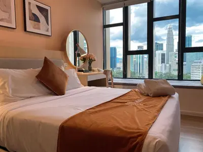 a bedroom with a large bed with a view of a city at Ceylonz Seasonal Suites in Kuala Lumpur