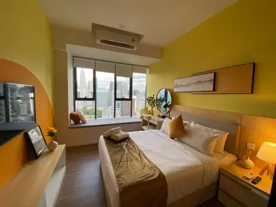 a bedroom with a large bed and a window at Ceylonz Seasonal Suites in Kuala Lumpur