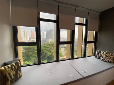 a room with a large window with a view of a city at Ceylonz Seasonal Suites in Kuala Lumpur