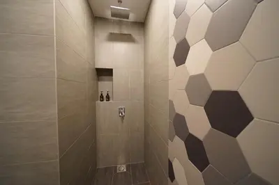 a bathroom with a shower with brown and white tiles at Ceylonz Starlight Suites Bukit Bintang in Kuala Lumpur