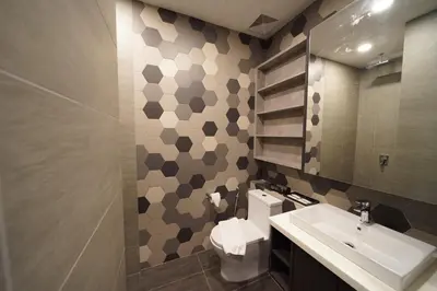 a bathroom with a sink and a toilet and a mirror at Ceylonz Starlight Suites Bukit Bintang in Kuala Lumpur