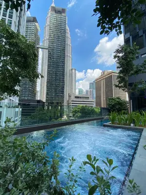 a swimming pool in a city with tall buildings at Star Suites KLCC in Kuala Lumpur
