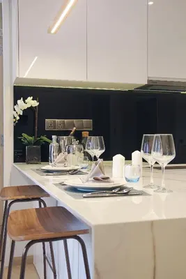 a white counter with three wine glasses on it at Star Suites KLCC in Kuala Lumpur