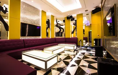 a lobby with a purple couch and yellow walls at Star Suites KLCC in Kuala Lumpur