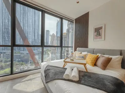 a bedroom with a bed with a large window at Scarletz Suites KLCC in Kuala Lumpur