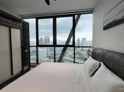 a bedroom with a white bed and a large window at Scarletz Suites KLCC in Kuala Lumpur