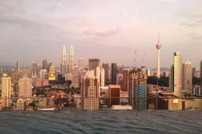 a view of a city skyline with buildings at KLCC Regalia Suites Infinity Pool Kuala Lumpur in Kuala Lumpur