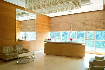 a living room with a bar and a chandelier at KLCC Regalia Suites Infinity Pool Kuala Lumpur in Kuala Lumpur