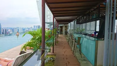 a bar on a building with a view of the water at Regalia Suites Infinity Pool Kuala Lumpur in Kuala Lumpur