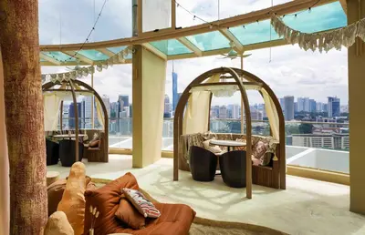 a living room with a view of a city at Regalia Suites Infinity Pool Kuala Lumpur in Kuala Lumpur