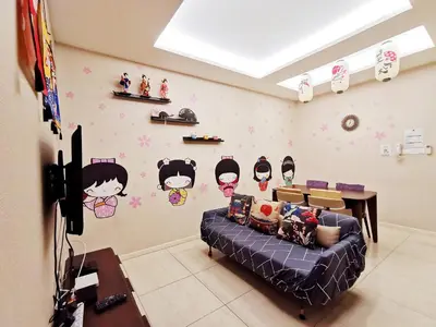 a living room with a couch and some stickers on the wall at Dorsett Residences Kuala Lumpur in Kuala Lumpur