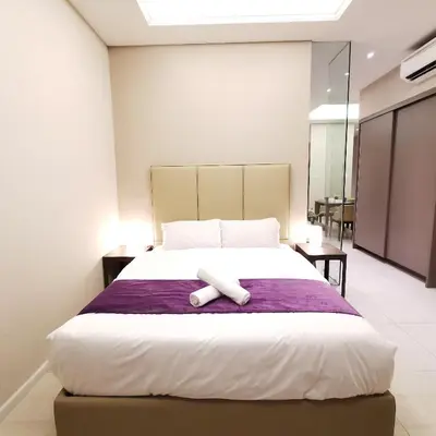 a bedroom with a bed with a towel on it at Dorsett Residences Kuala Lumpur in Kuala Lumpur