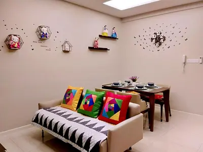 a dining room with a table and a bench with colorful pillows at Dorsett Residences Kuala Lumpur in Kuala Lumpur