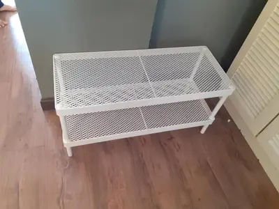 a white wire shelf in the corner of a room at Omar's Place 2 in Kuala Lumpur