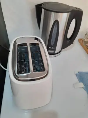 a coffee maker and acomputer on a table at Omar's Place 2 in Kuala Lumpur