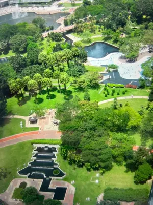an aerial view of a park with trees and water at KLCC City SkySuites in Kuala Lumpur